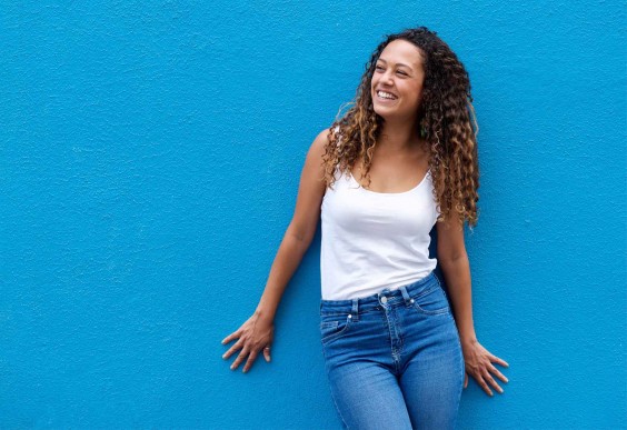 Happy Woman Against Blue Wall