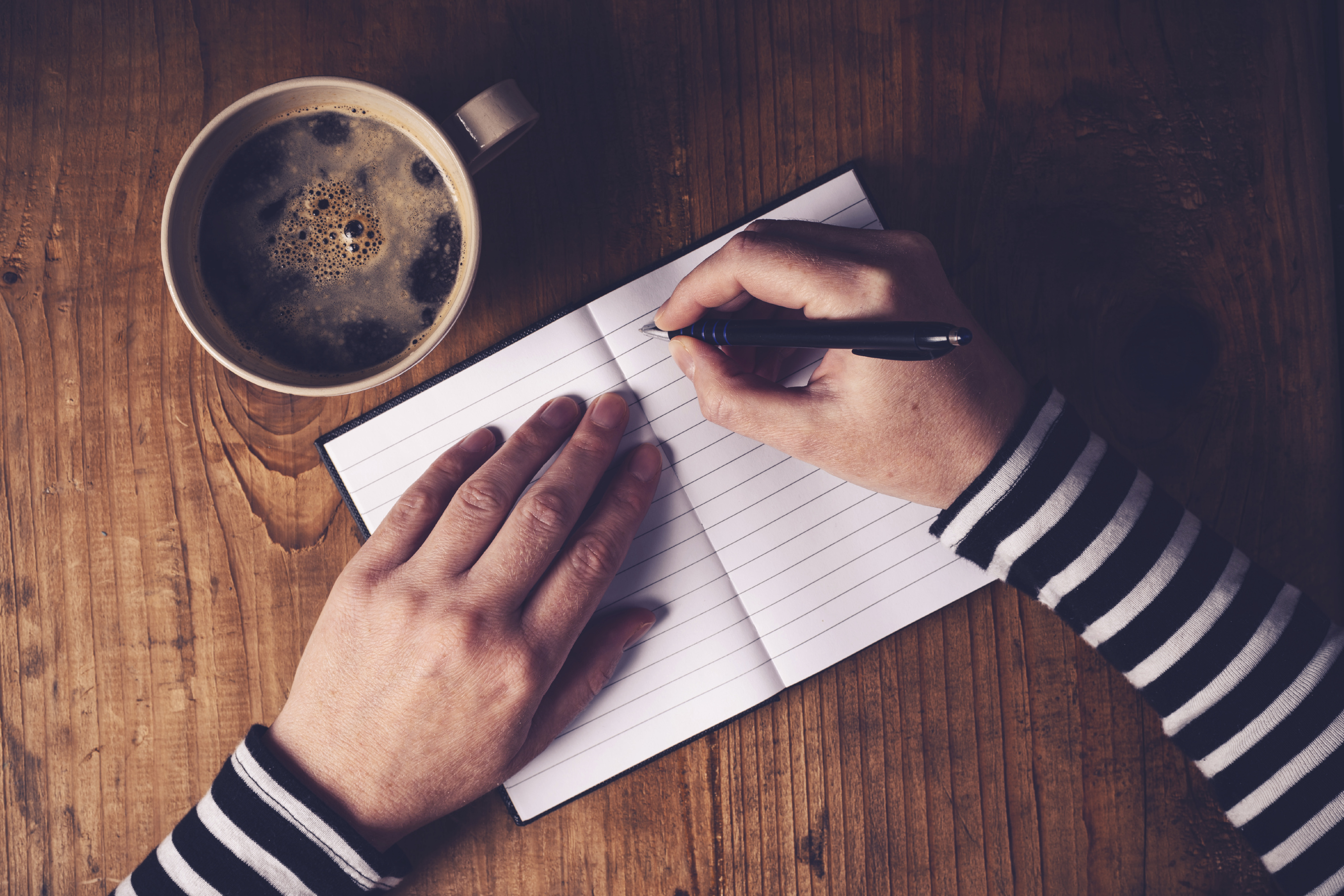 coffee and hands journaling